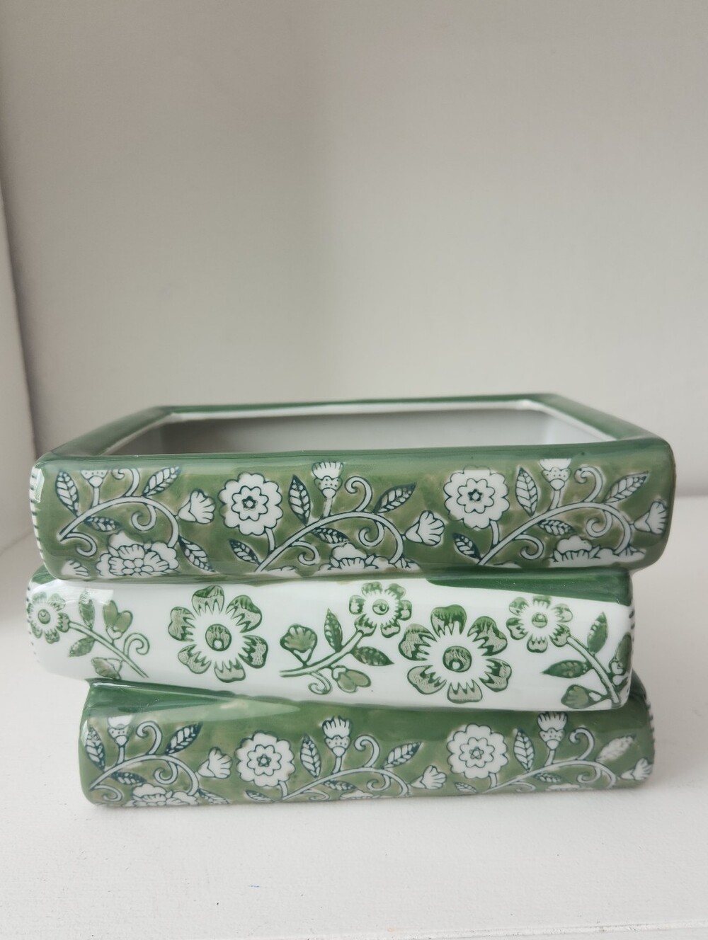 ceramic book stack planter styled with a traditional Green & white chinoiserie
